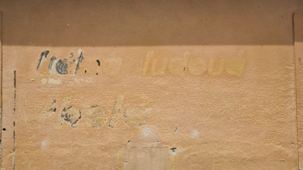 Na stene školy sa zachoval náznak pôvodného nápisu